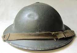 British Wardens Helmet with dents and post war green paint